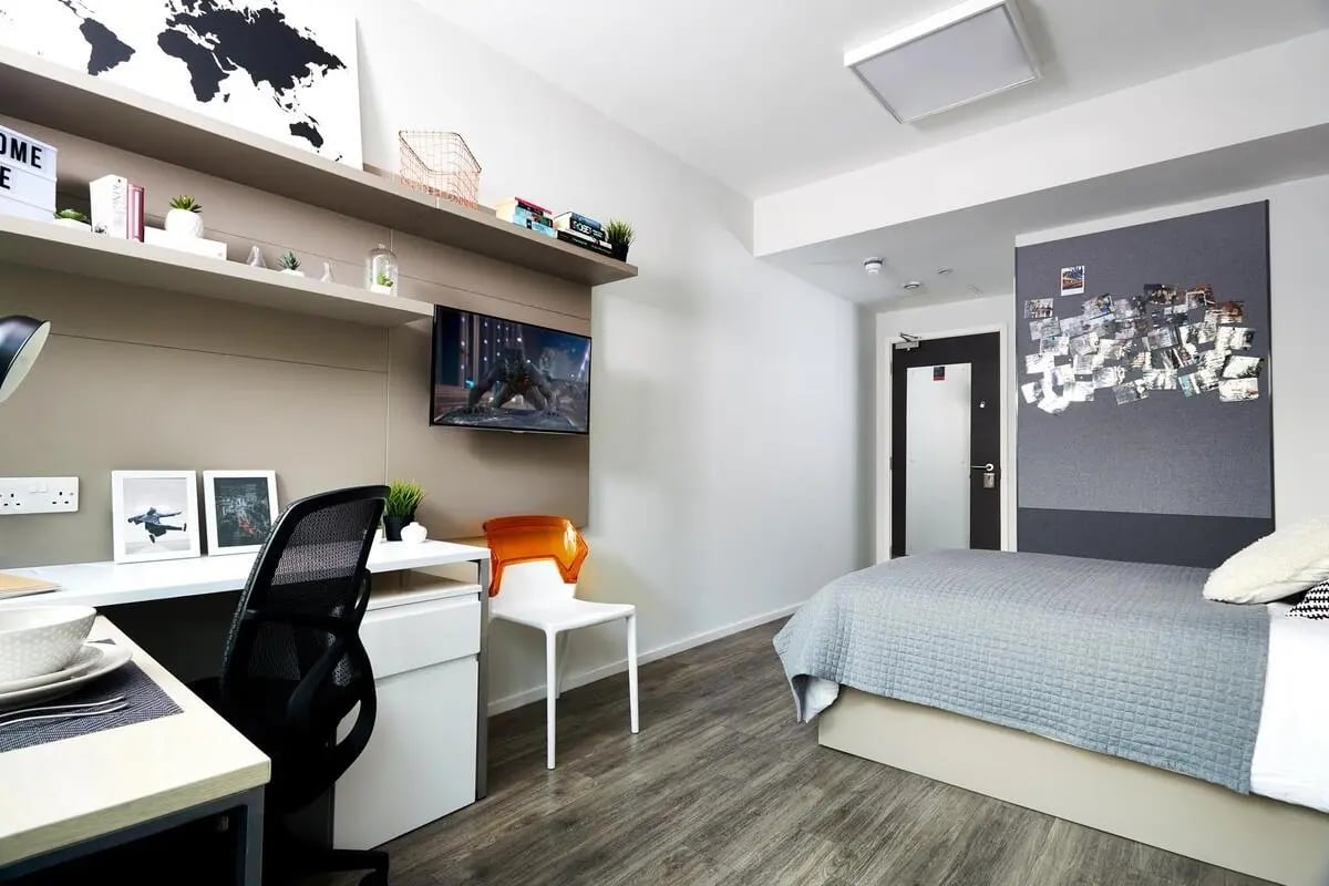 Desk bed chair television corkboard bedroom at Vita Student Portland Crescent in Leeds Student Accommodation