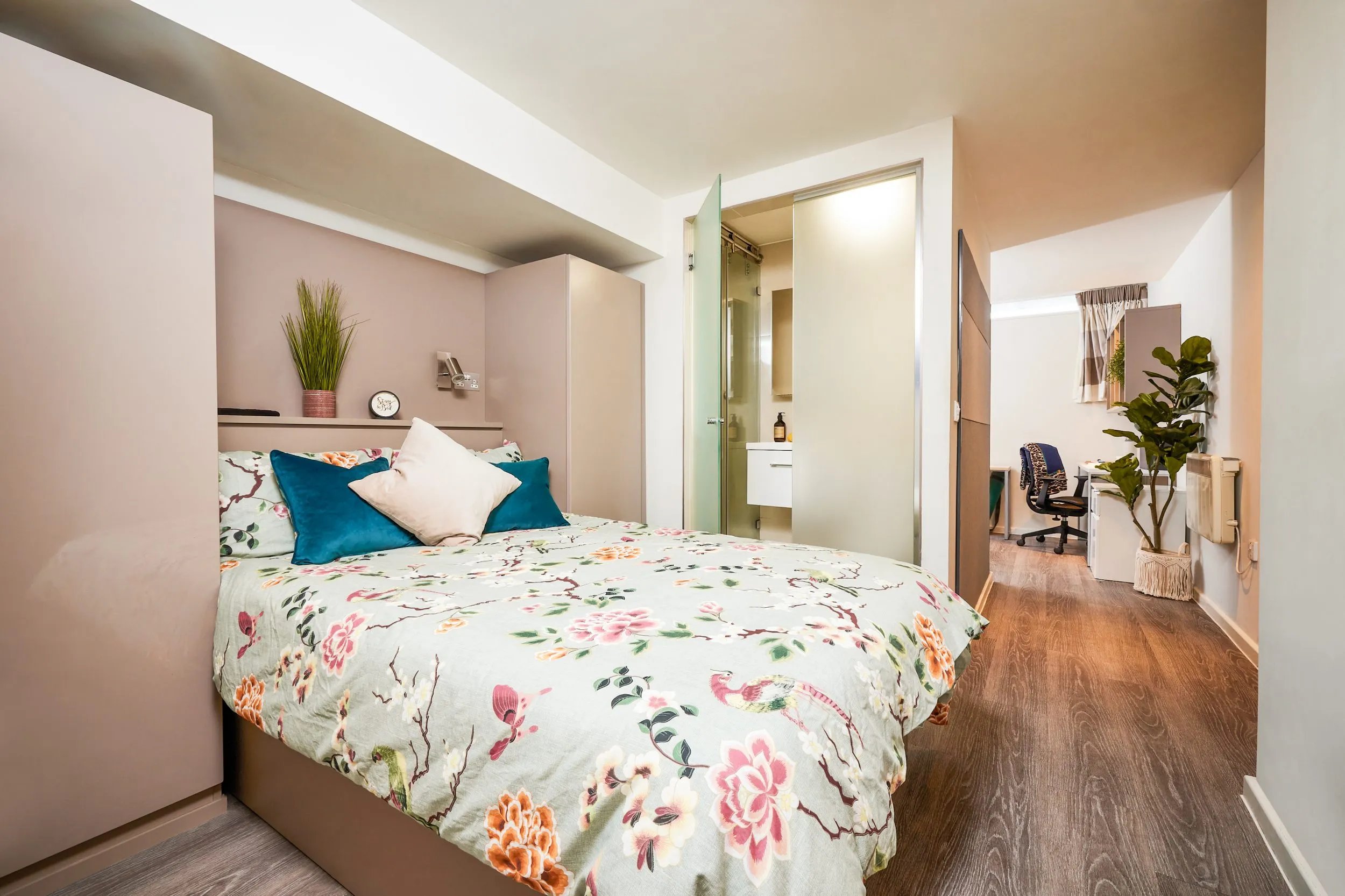 Floral duvet bed with teal pillows and wardrobe bedroom at Vita Student Crosshall Street in Liverpool Student Accommodation
