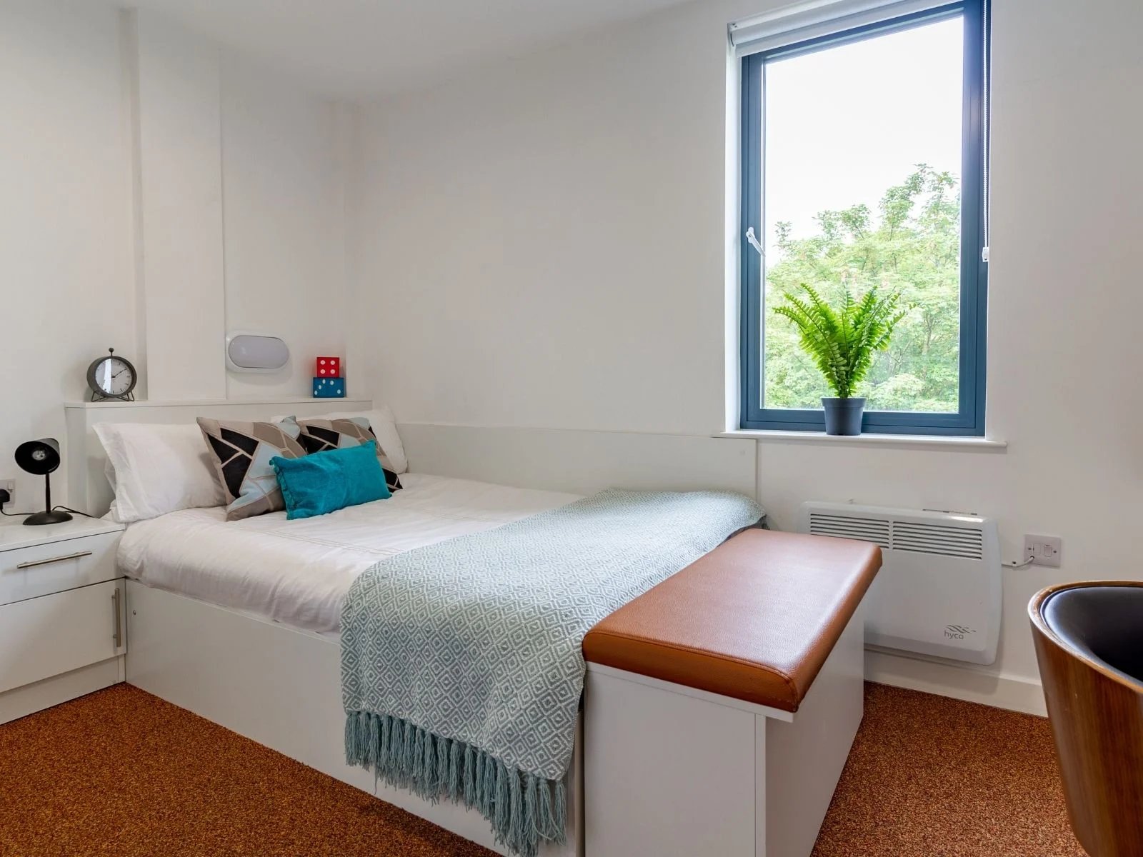 Bed pillows throw blanket bedside table clock Bedroom at The Shield in Newcastle Upon Tyne Student Accommodation