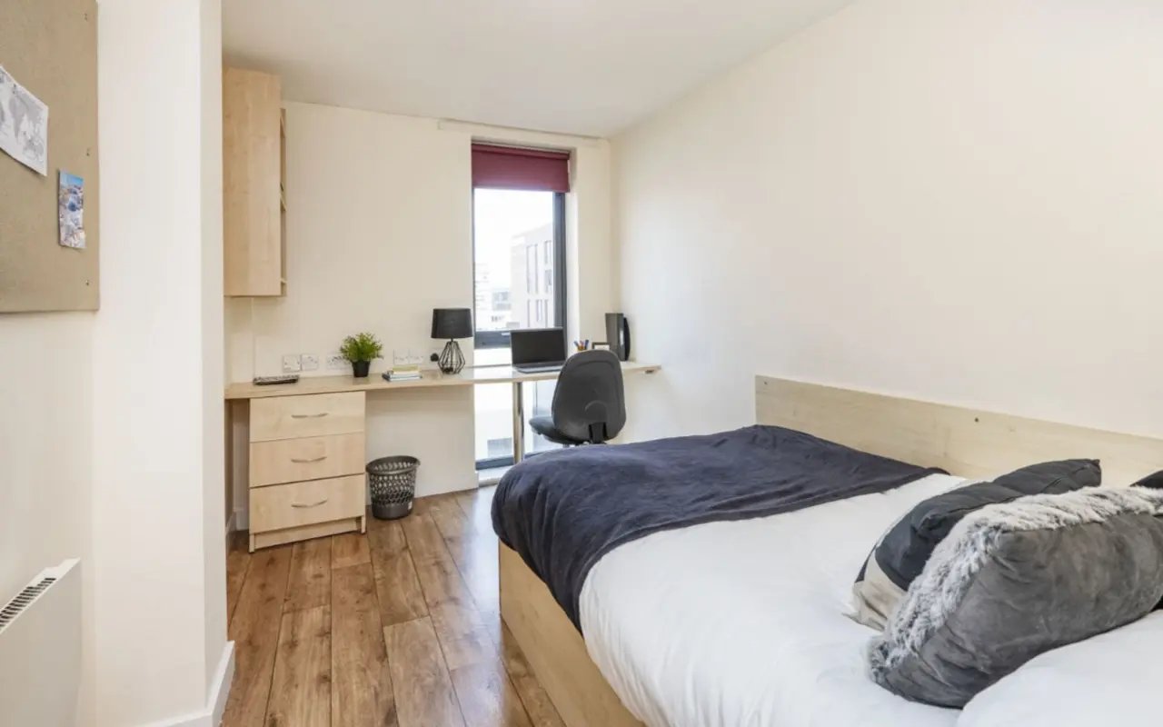 Bed desk chair laptop and plant bedroom at Rockingham House in Sheffield Student Accommodation