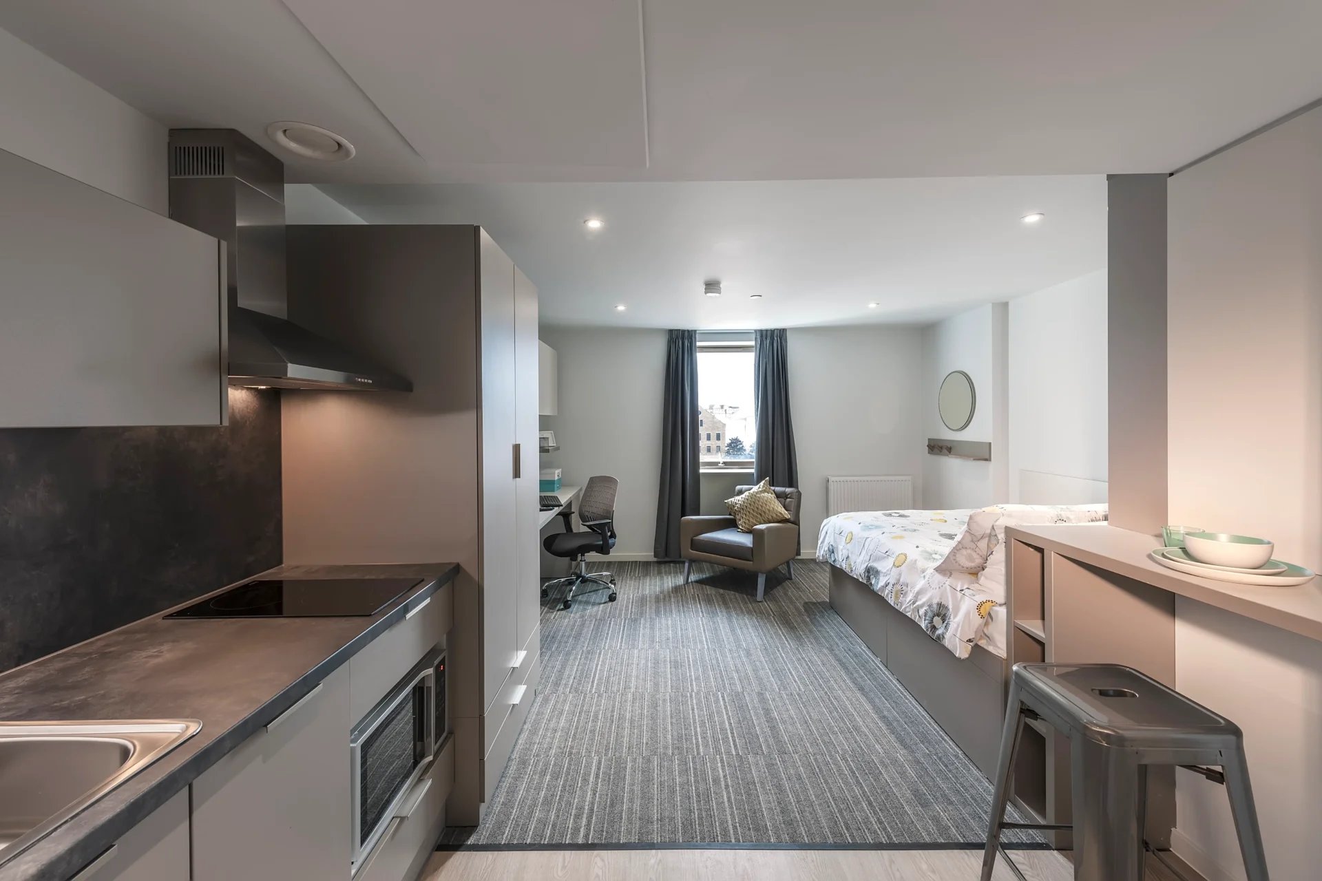 Bed desk chair and kitchen student studio apartment at CitySide in Leeds Student Accommodation