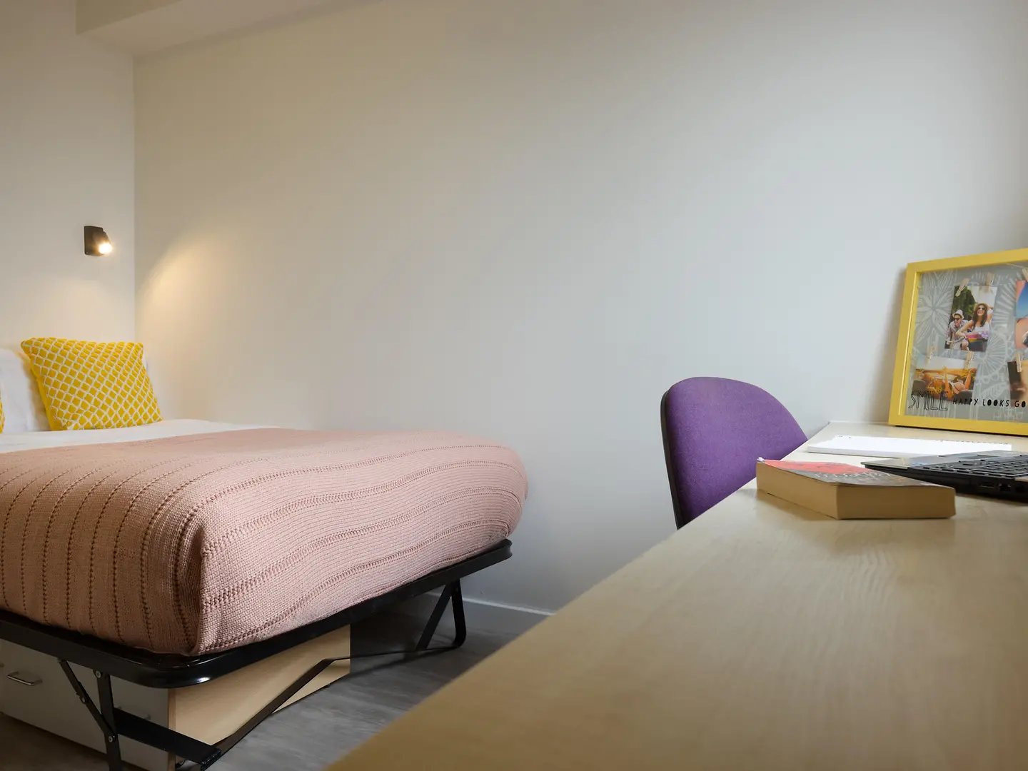 Bed with pink blanket yellow pillow study desk bedroom at Yugo Knoll Court in Newcastle Upon Tyne Student Accommodation