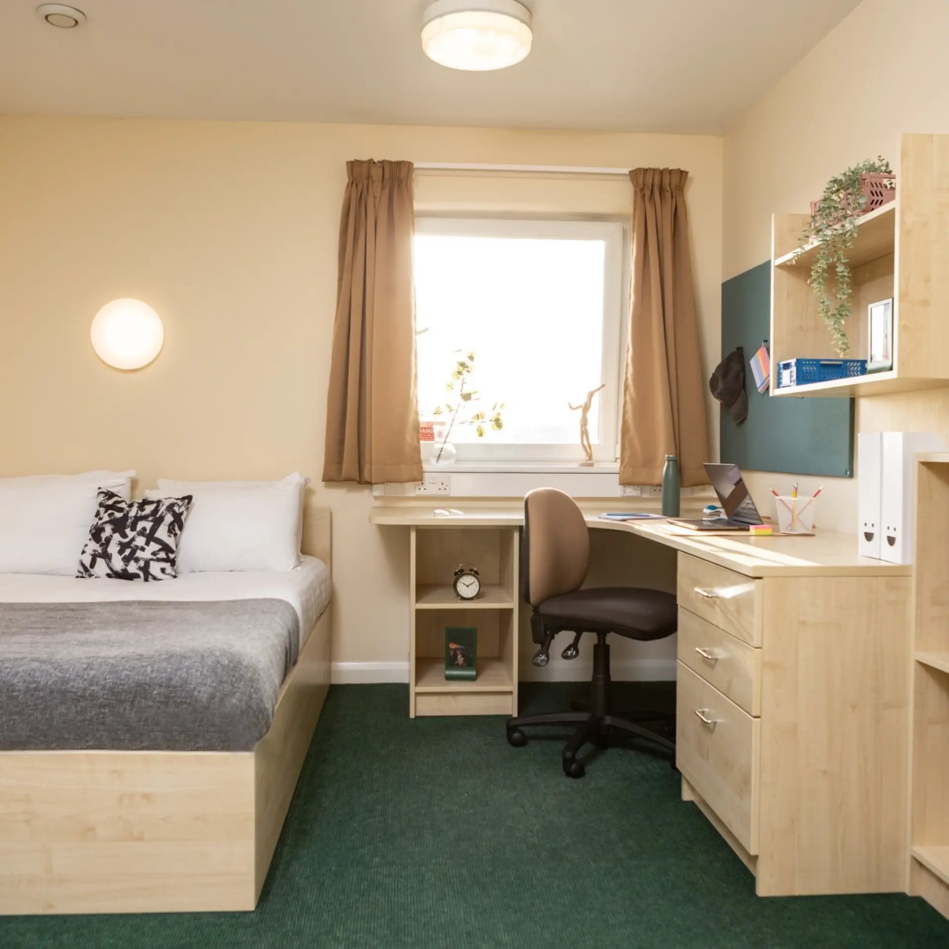 Bed desk chair shelving and window bedroom at Newport Student Village in Newport Student Accommodation