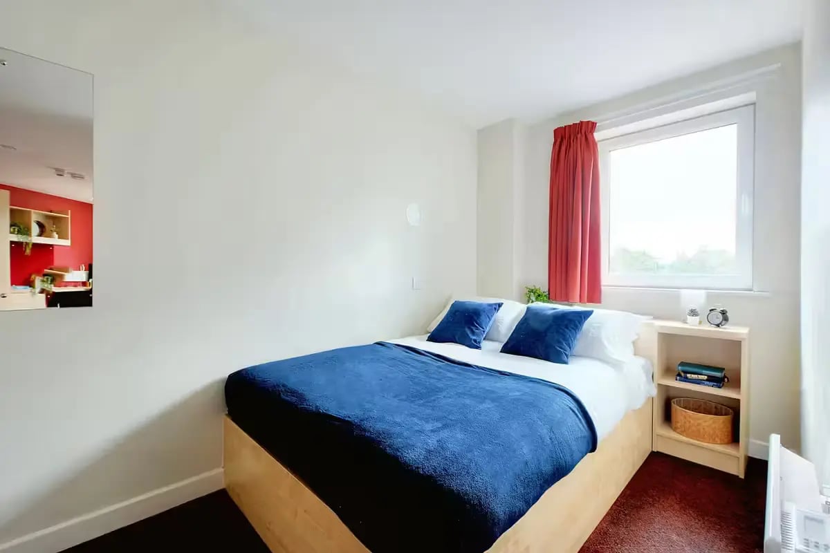 Bed with blue covers and pillows bedroom at Nottingham Two in Nottingham Student Accommodation
