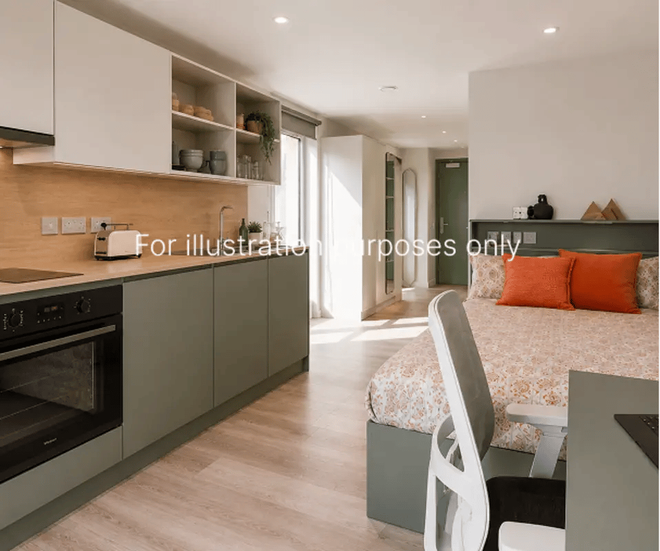 Kitchen area and bed with orange pillows Studio at City Wharf in Glasgow Student Accommodation