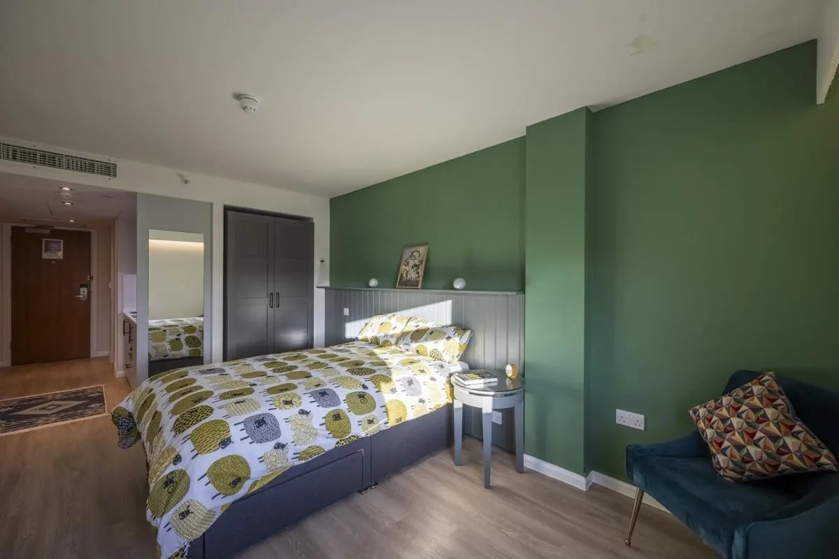 Bed wardrobe and chair student bedroom at St. Andrew Street in Aberdeen Student Accommodation