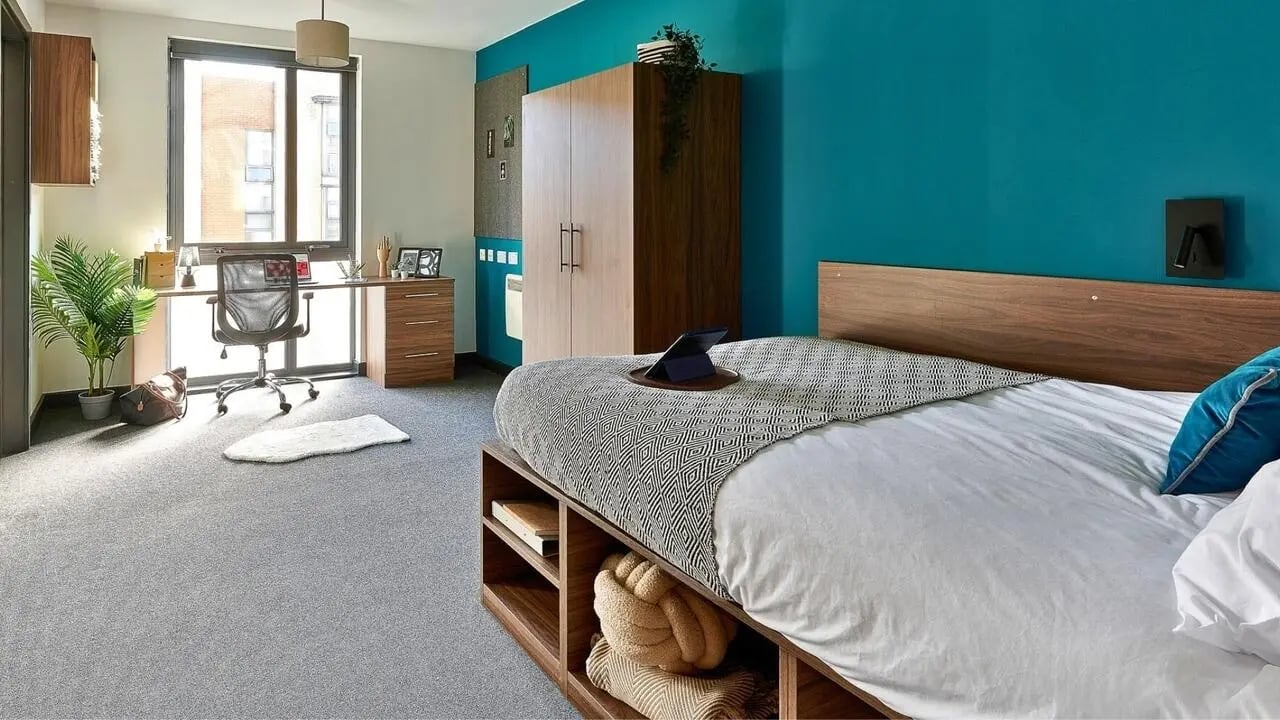 Desk chair plant bed wardrobe bedroom at Cavendish Place in Manchester Student Accommodation