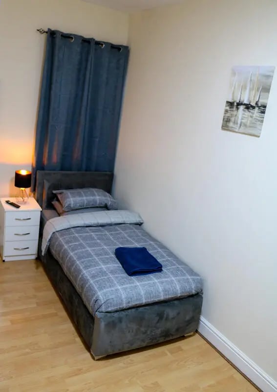 Bed bedside table curtains painting bedroom at 42 Disraeli Rd E7 9JP in London Student Accommodation