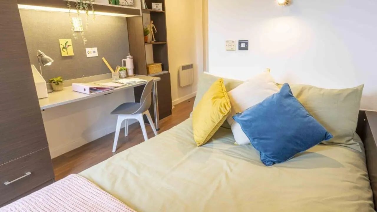 Bed with pillows study desk chair and wardrobe Bedroom at iQ Astor House in Plymouth Student Accommodation