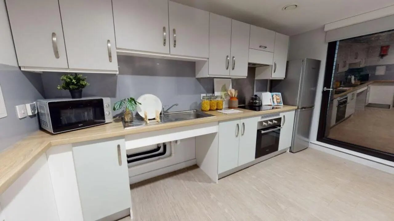 Modern kitchen with microwave fridge and oven kitchen at iQ Elgin Place in Glasgow Student Accommodation