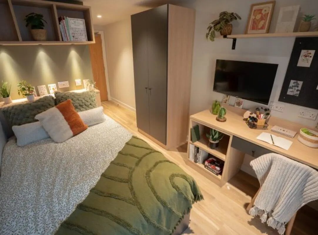 Bed wardrobe desk television and shelves bedroom at Fusion Students Fusion+LS1 in Leeds Student Accommodation