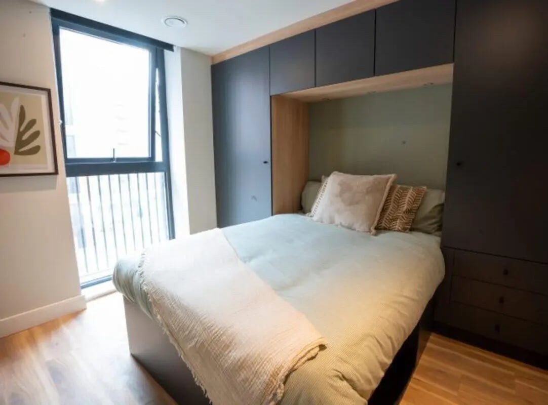 Bed with pillows and blanket bedroom at Fusion Students Brent Cross in London Student Accommodation