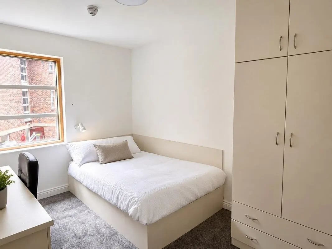 Bed desk chair closet bedroom at Truro Works in Sheffield Student Accommodation