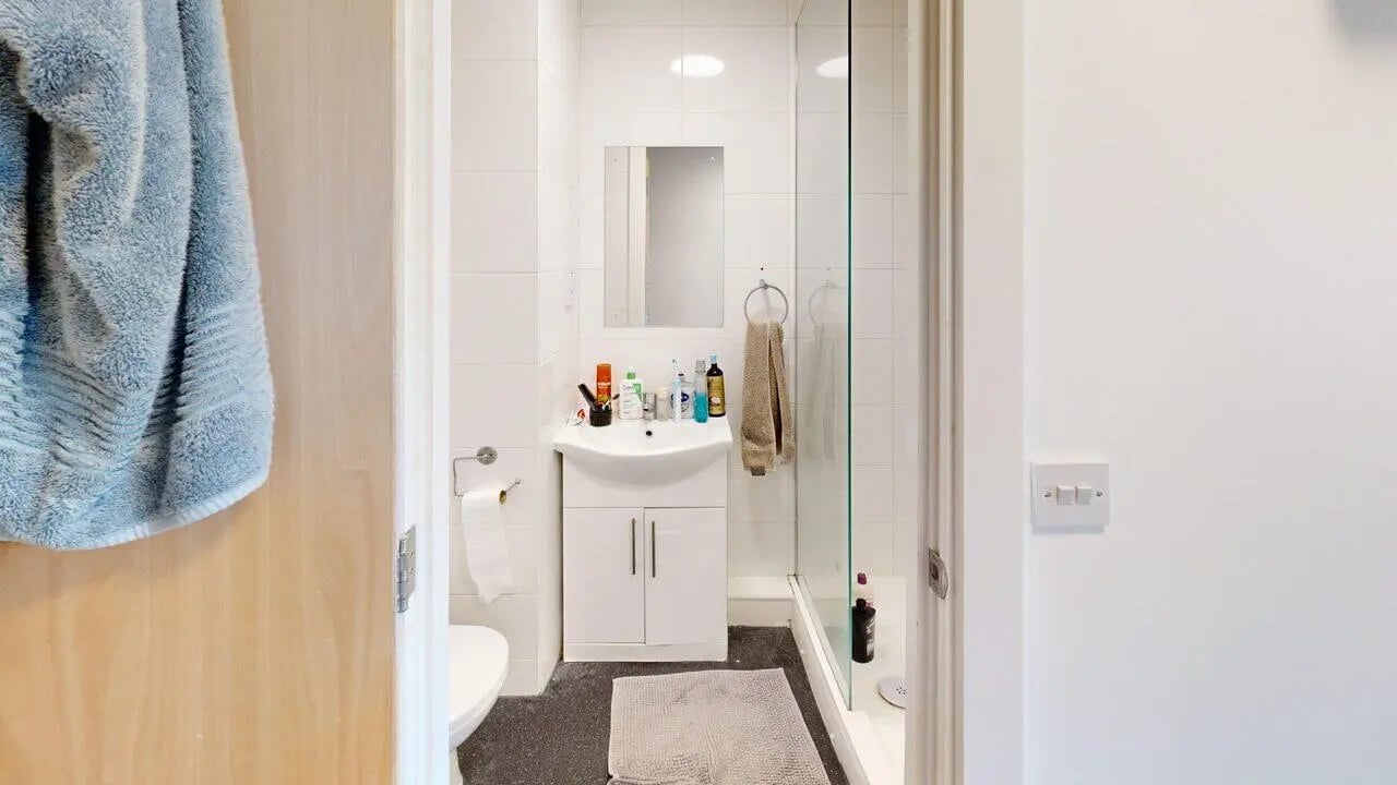 Sink vanity toilet shower and towel bathroom at Unity Square in Liverpool Student Accommodation