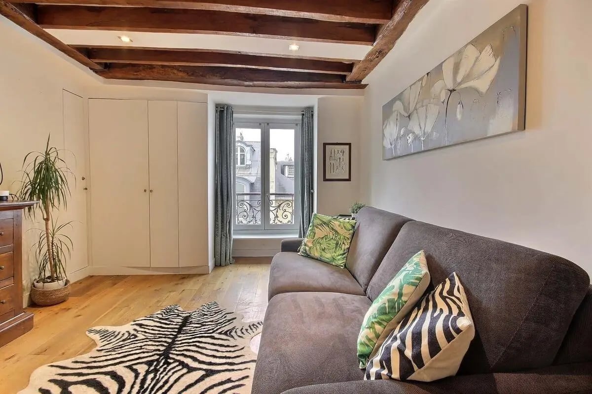 Sofa zebra rug plant large painting living room at Studio in Rue de Bourgogne, 75007 Paris, France in Paris Student Accommodation