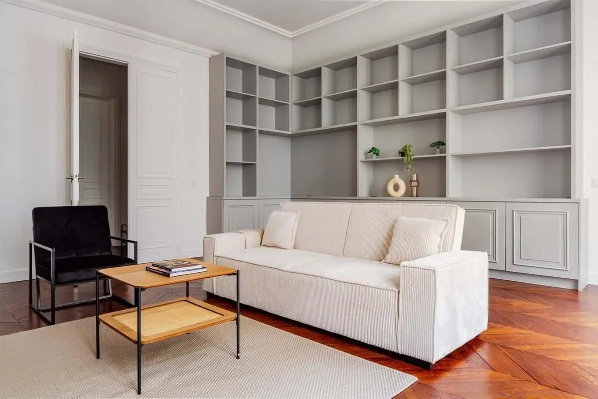 Sofa black chair coffee table bookshelf living room at Apartment in 2 Rue de Miromesnil, 75008 Paris, France in Paris Student Accommodation