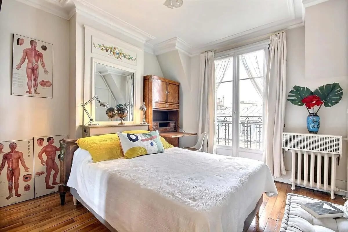 Bed with yellow pillows desk mirror and window bedroom at Apartment in Rue Régis, 75006 Paris, France in Paris Student Accommodation