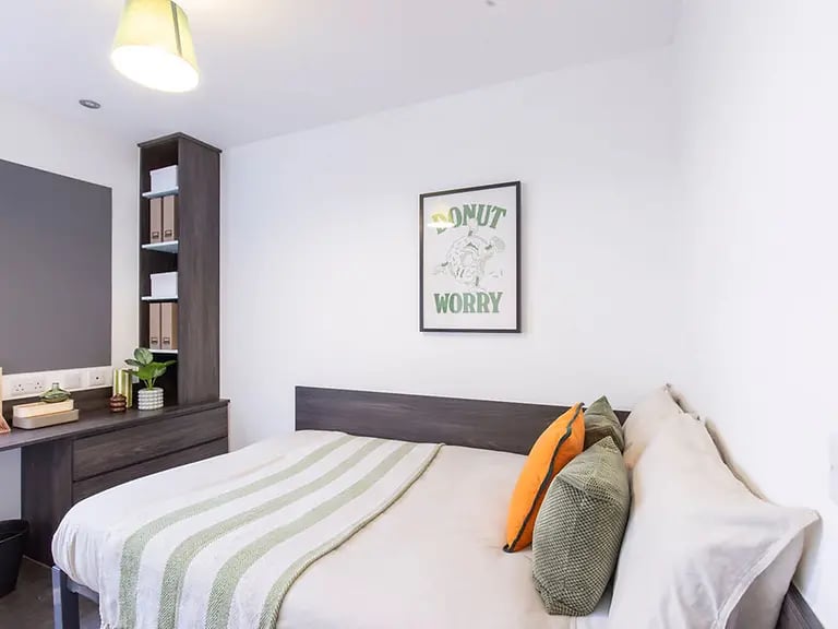 Bed desk shelf and poster bedroom at The Foundry Newcastle in Newcastle Upon Tyne Student Accommodation