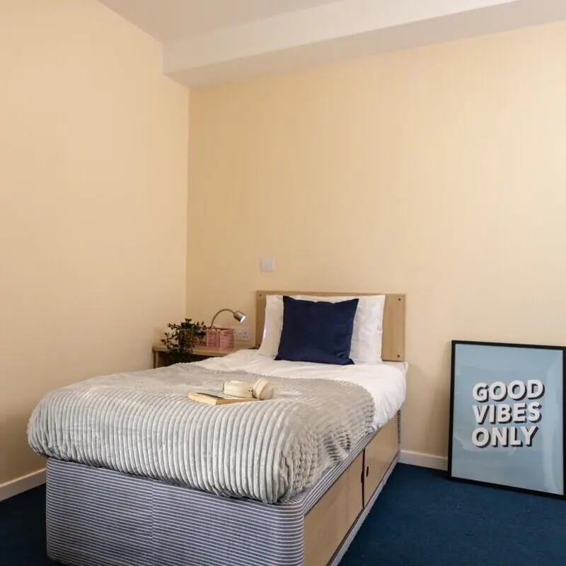 Bed with pillow lamp and artwork bedroom at Okeford House in Bournemouth Student Accommodation