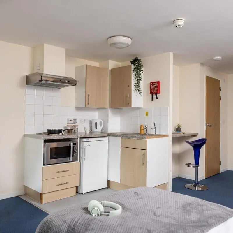 Kitchen with microwave fridge and barstool Kitchen at Lyme Regis House in Bournemouth Student Accommodation