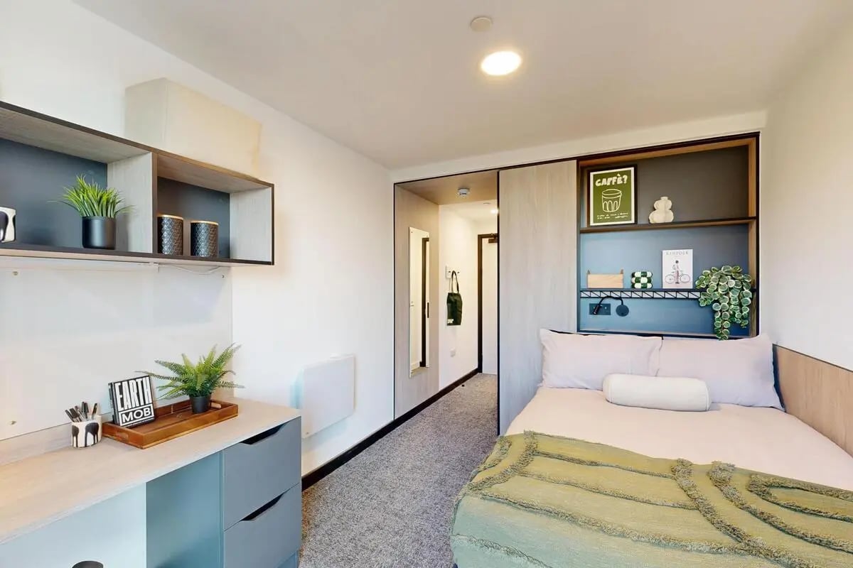 Bed desk and shelves with plants bedroom at Bridgeside in Nottingham Student Accommodation