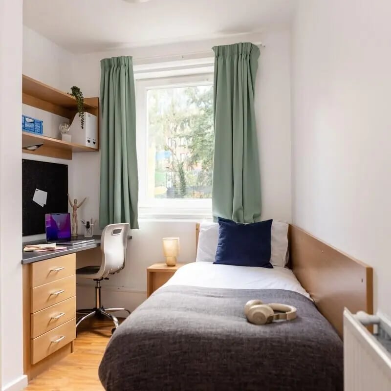 Desk bed headphones and shelves bedroom at Cranborne House in Bournemouth Student Accommodation