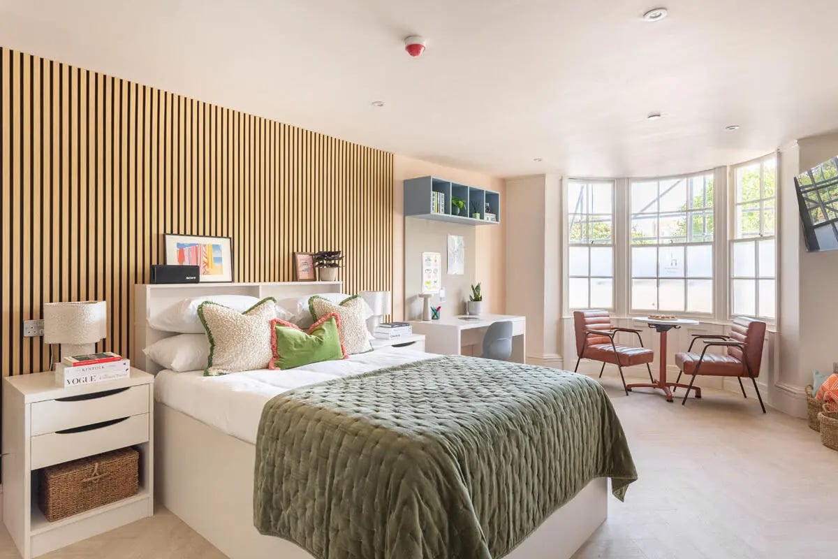 Bed desk chairs and windows bedroom at Hamilton House in Brighton Student Accommodation