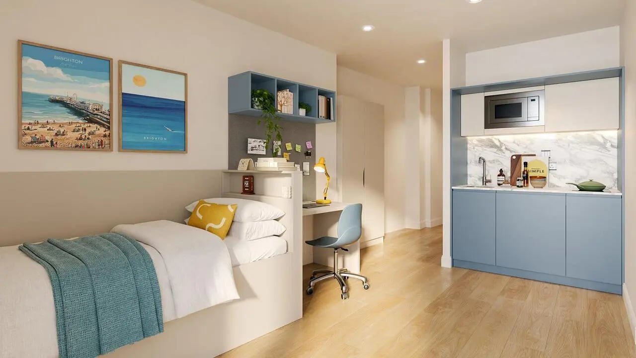Bed desk kitchen area with microwave and sink bedroom at Hamilton House in Brighton Student Accommodation