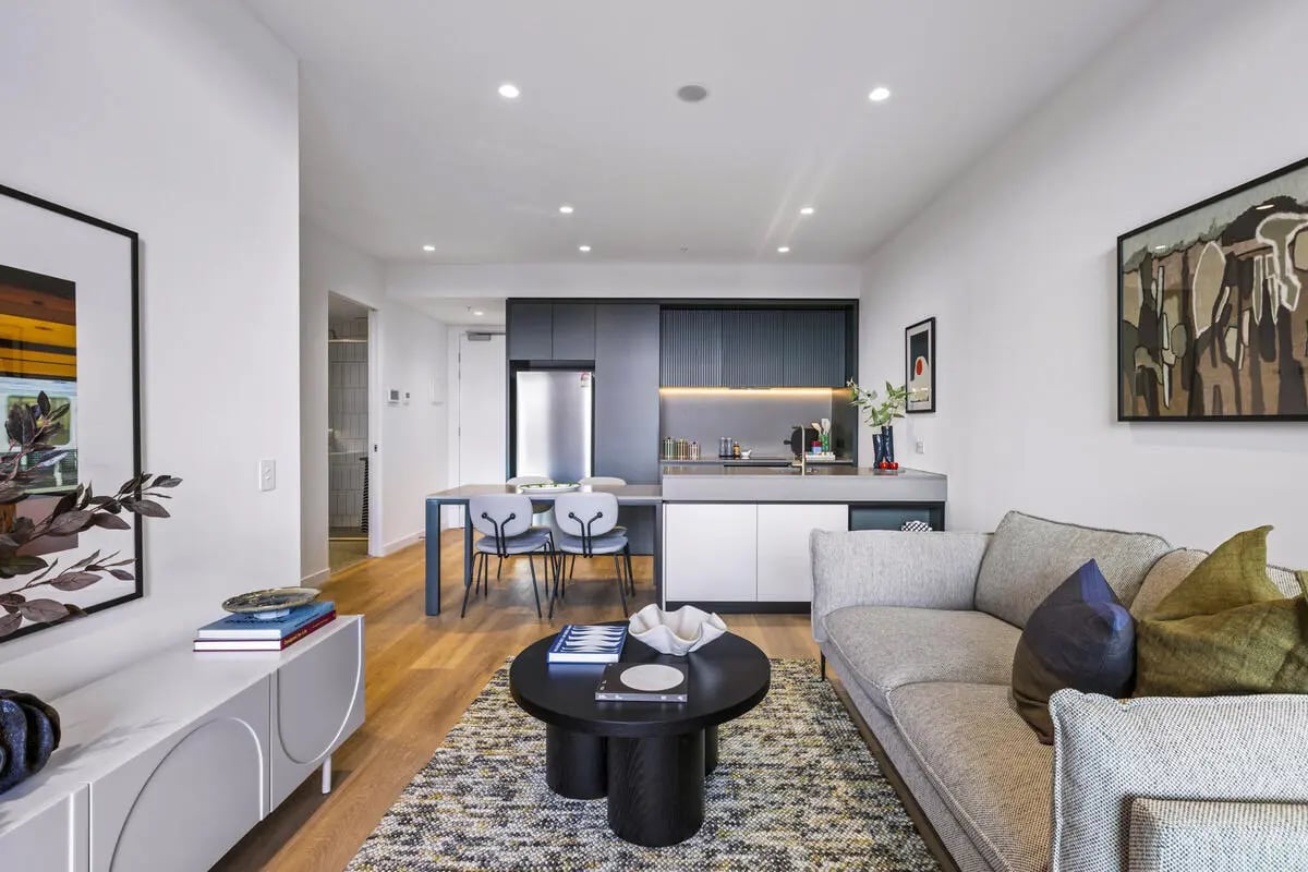 Living area with sofa kitchen and dining area at Indi Footscray in Melbourne Student Accommodation