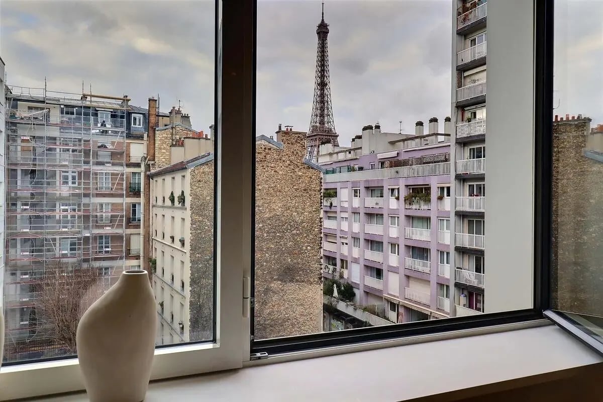 Eiffel Tower view from window with vase exterior at Apartment in Pass. du Guesclin, 75015 Paris, France in Paris Student Accommodation