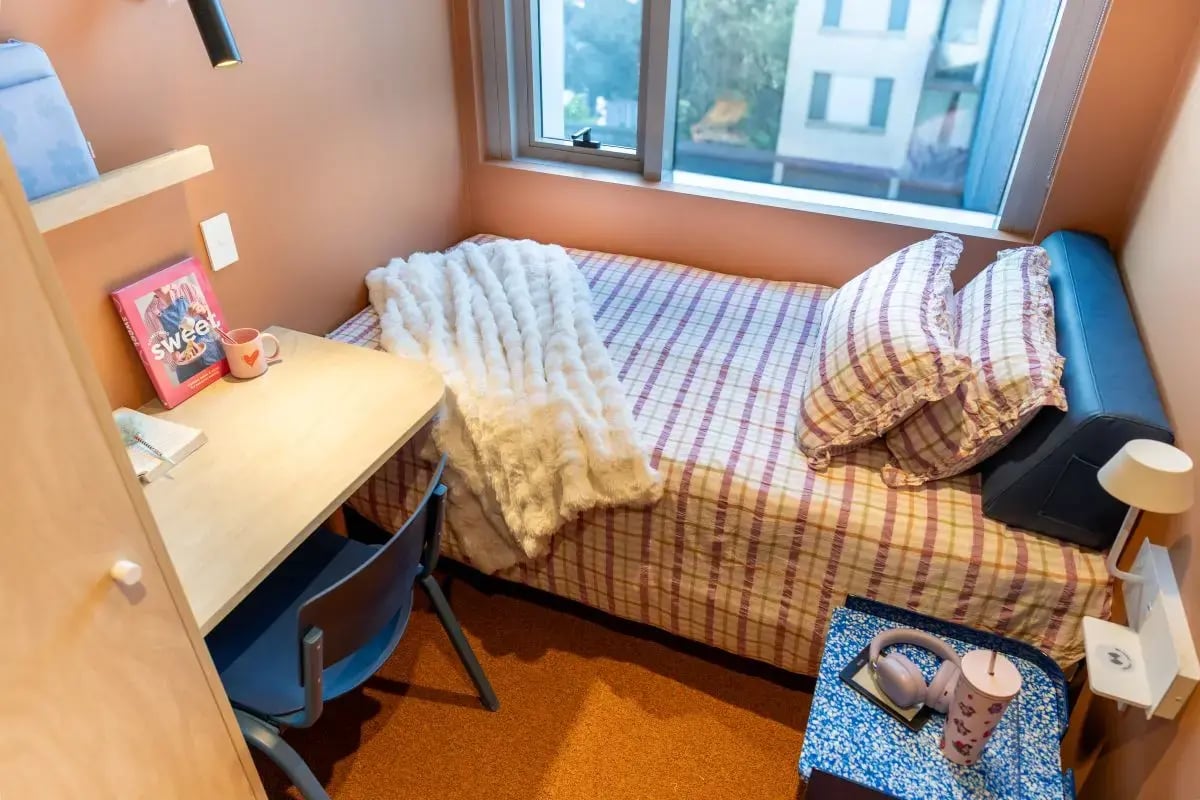 Bed desk chair pillows blanket and mug bedroom at The Switch Lachlan Macquarie Park in Sydney Student Accommodation