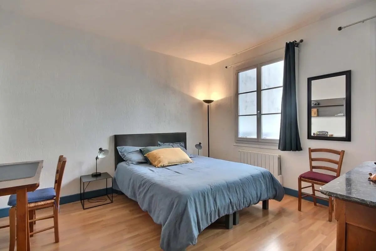 Bed table lamp floor lamp mirror chair bedroom at Apartment in Rue Bergère, 75009 Paris, France in Paris Student Accommodation