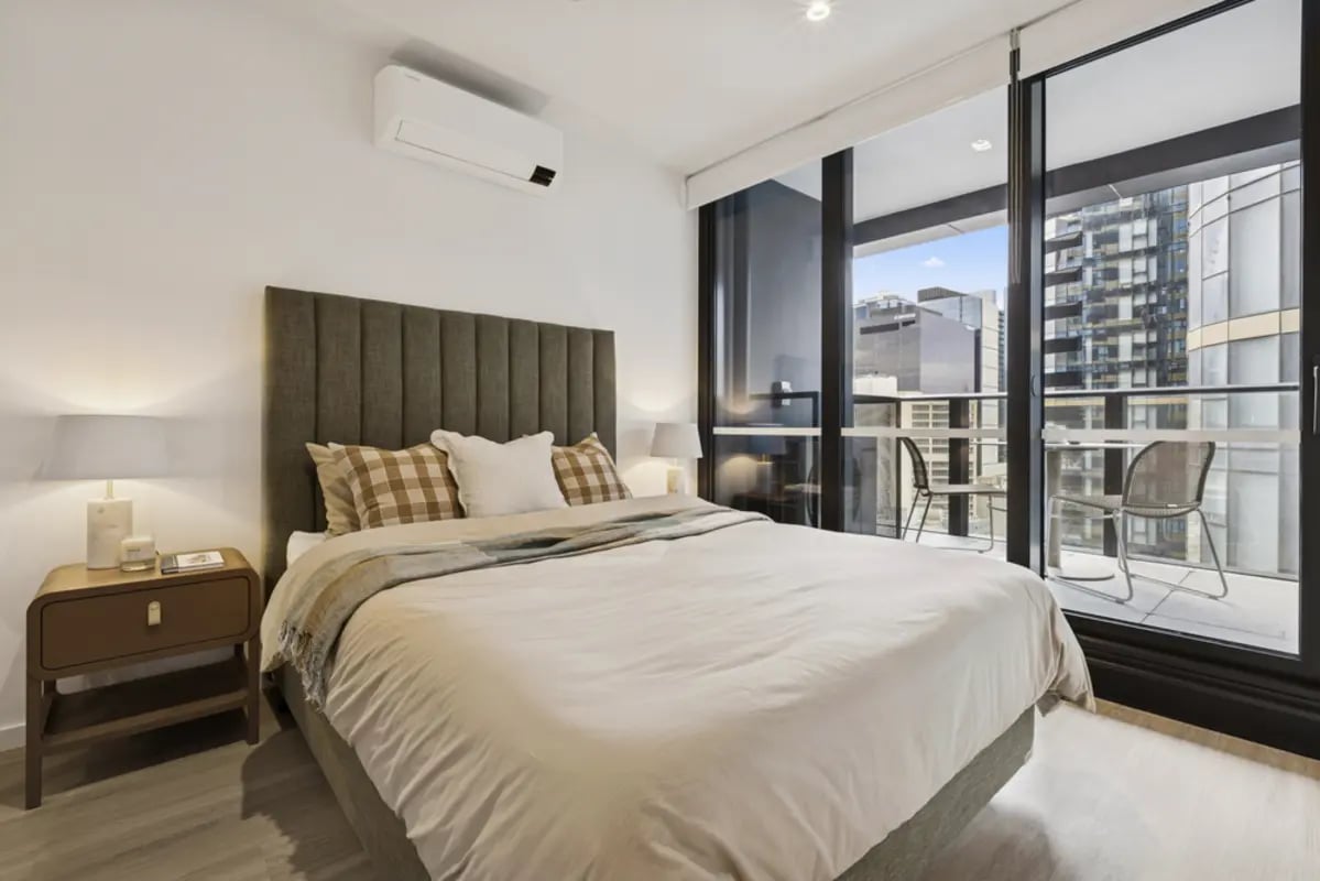 Bed nightstand air conditioner balcony bedroom at West Tower, Melbourne Quarter in Melbourne Student Accommodation