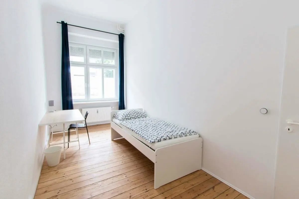 Bed desk chair window and curtains bedroom at Room in Detmolder Str., 10713 Berlin, Germany in Berlin Student Accommodation