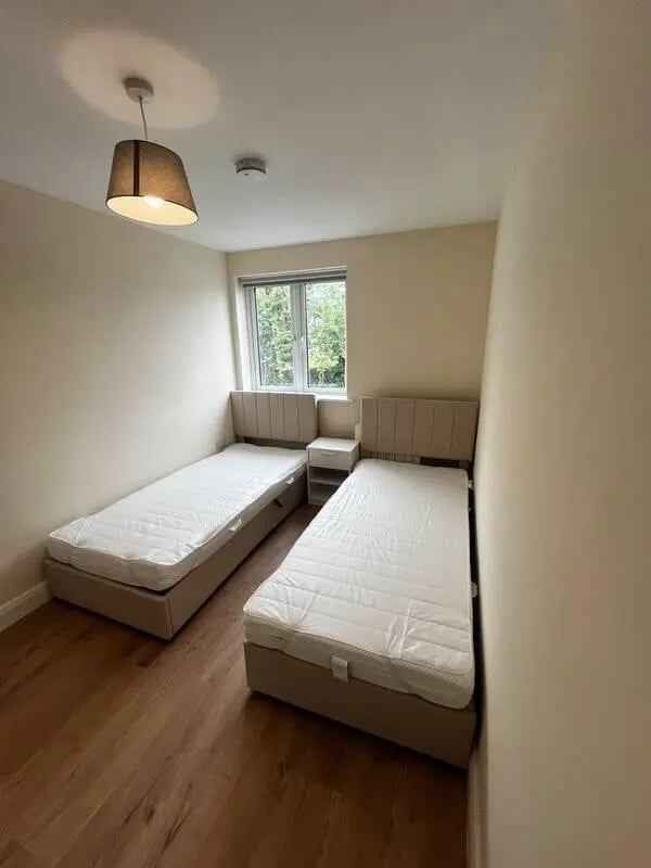 Two beds bedside table window bedroom at 16 Emmet Lodge, Emmet Court, Dublin 8 D08 EY83 in Dublin Student Accommodation