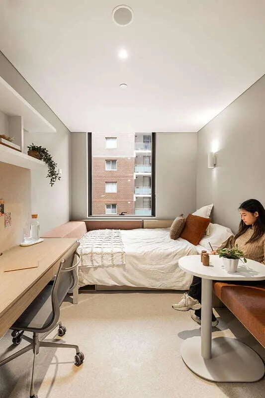 Bed desk seating and round table bedroom at Iglu Mascot Duo in Sydney Student Accommodation