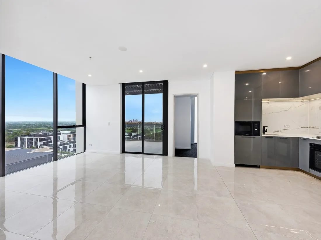 Modern kitchen with grey cabinets microwave and oven Living room at Belong Eastgardens in Sydney Student Accommodation
