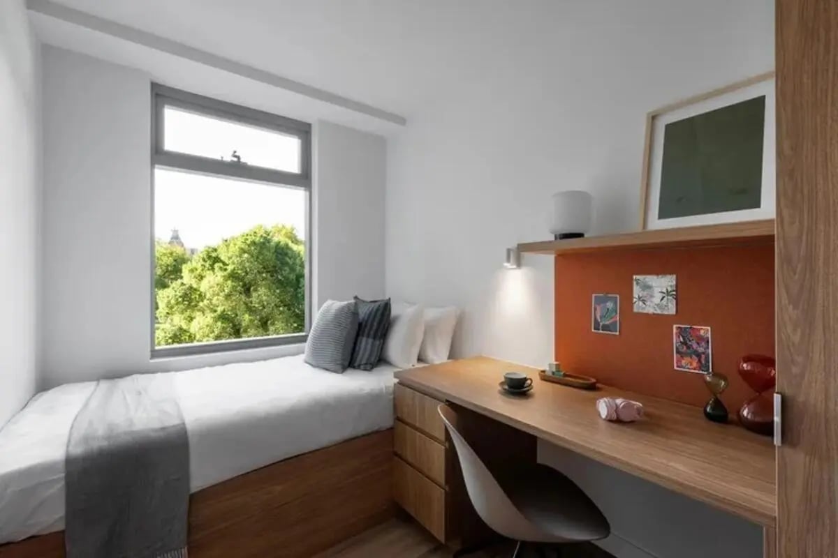 Bed desk with chair and artwork Bedroom at Campus House in Melbourne Student Accommodation