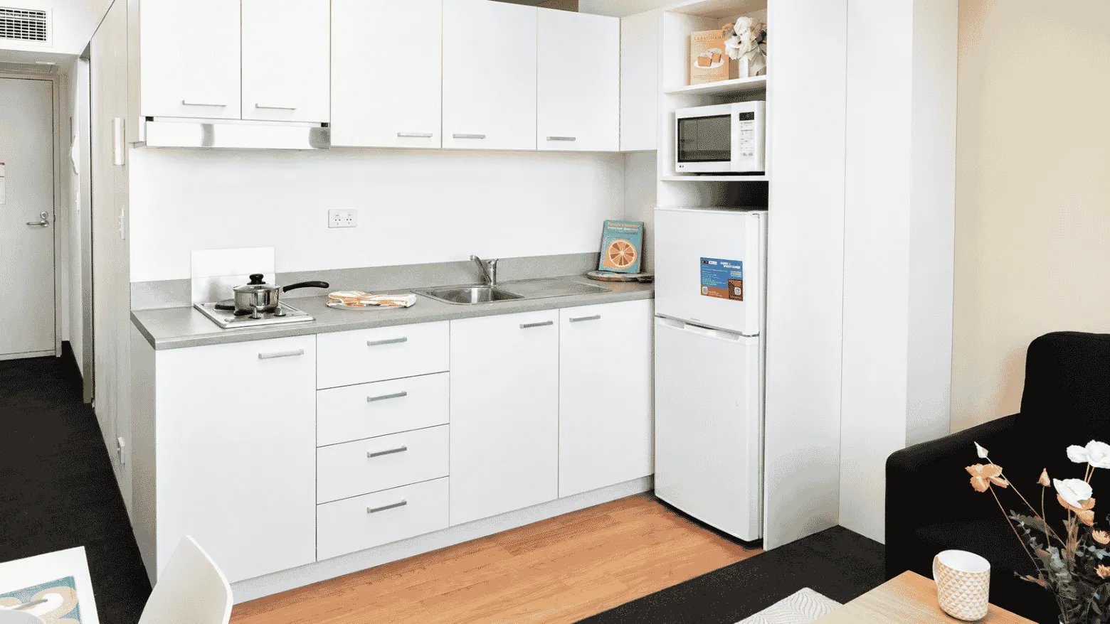 White cabinets fridge microwave sink and stove kitchen at UniLodge @ Metro Adelaide in Adelaide Student Accommodation