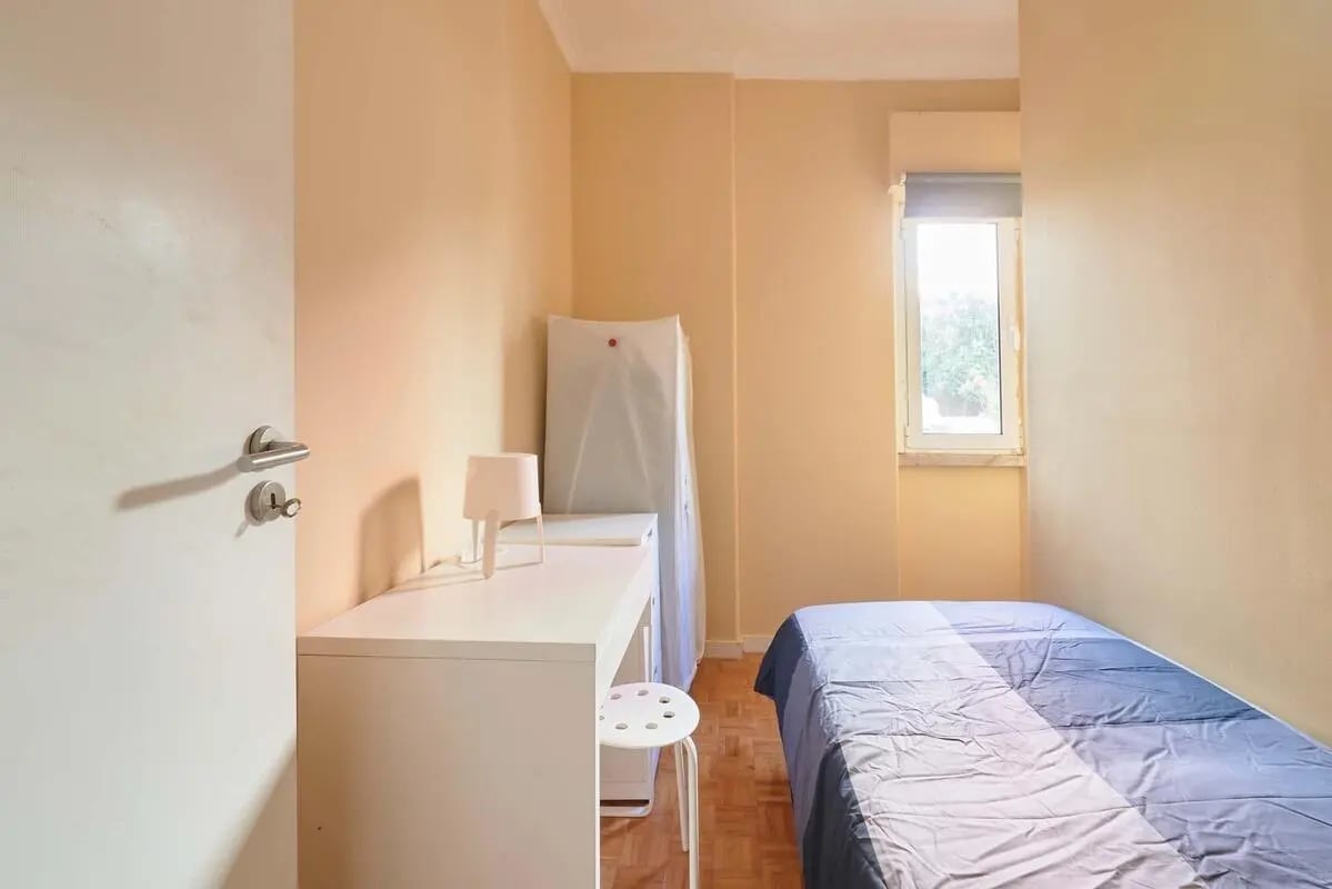Bed desk stool lamp and closet bedroom at Casa Abel II – Room 5 in Lisbon Student Accommodation