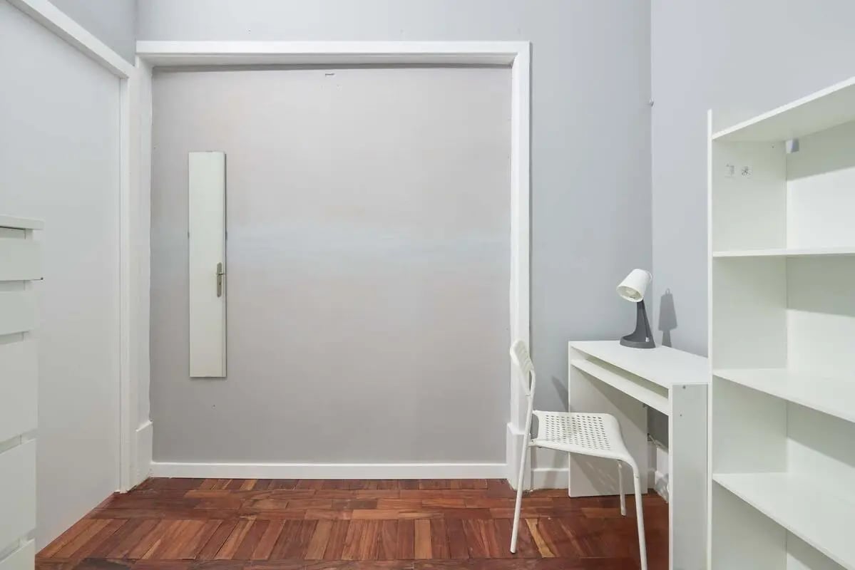 White desk chair lamp and bookshelf study area at Casa Elias III – Room 11 in Lisbon Student Accommodation