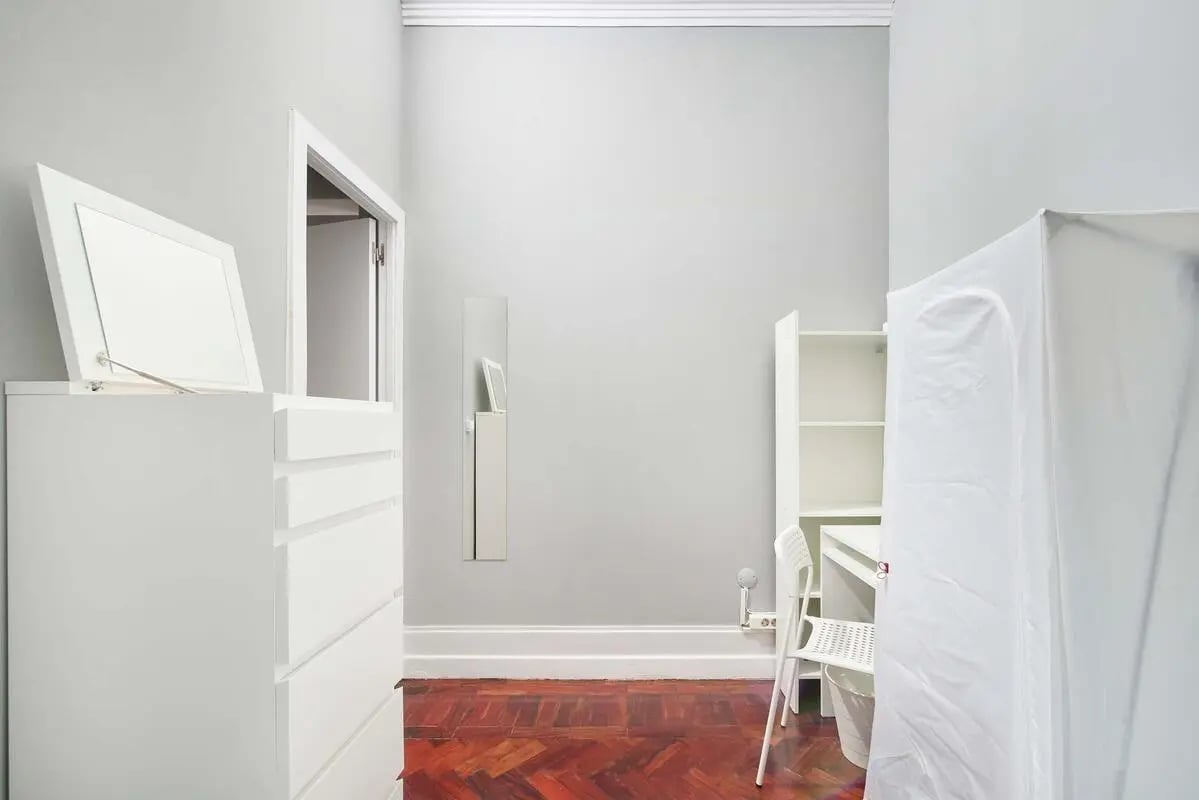 White dresser mirror door open desk shelves chair study area at Casa Elias III – Room 11 in Lisbon Student Accommodation