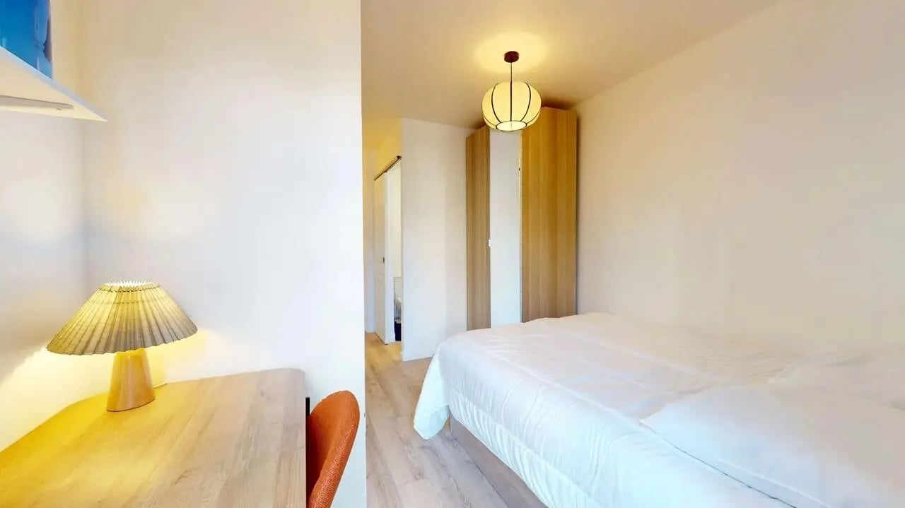 Desk lamp white duvet wardrobe wooden floor bedroom at Bovary House - Room S (11) in Paris Student Accommodation