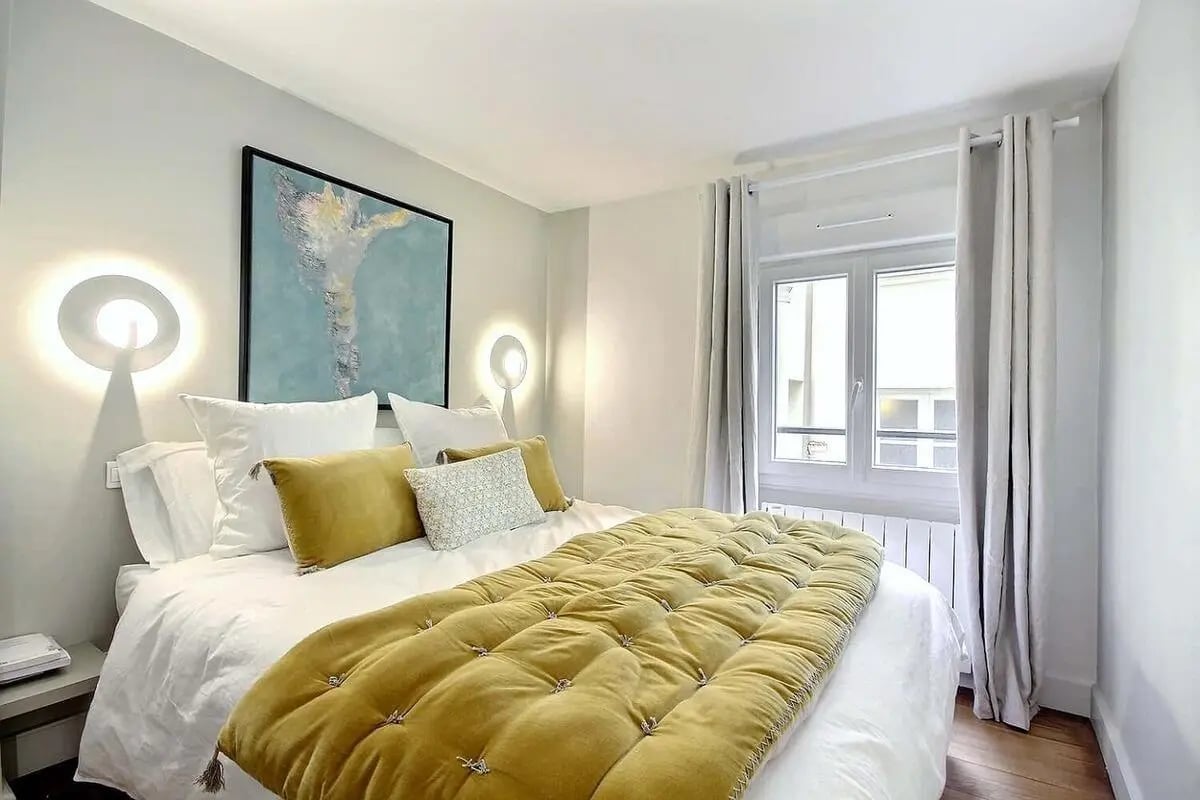 Bed artwork and wall lights bedroom at Apartment 1 bedroom 60m² in Paris Student Accommodation