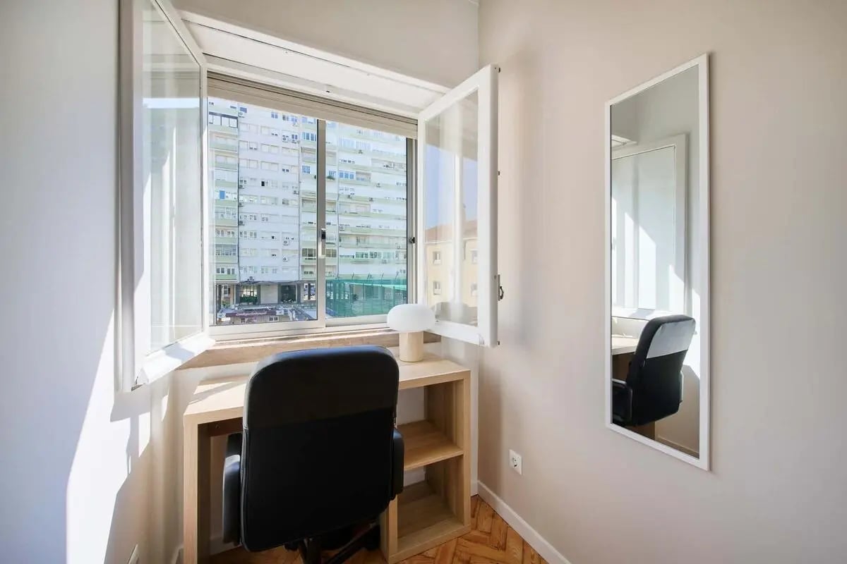 Desk chair and lamp by window study area at Bedroom in a 10-Bedroom Apartment in Avenida Estados Unidos da América, Lisbon - Room 1 in Lisbon Student Accommodation