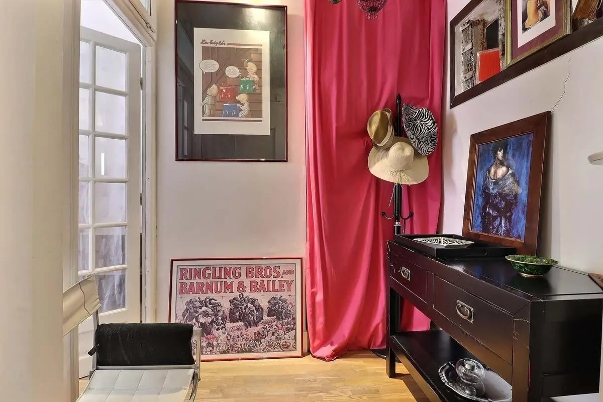 Poster artwork hats and a dark console table entry hall at Apartment 2 bedrooms 63m² in Paris Student Accommodation