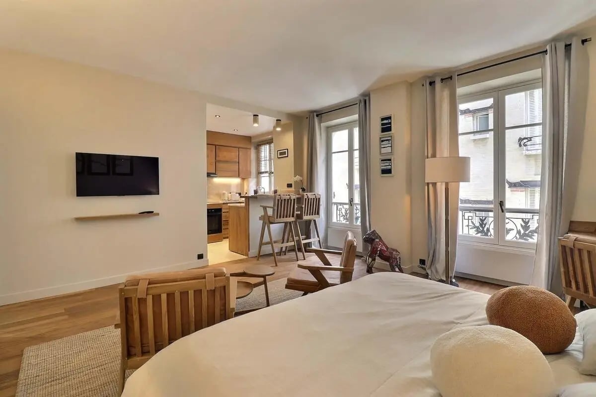 Bed kitchen bar chairs television studio apartment at Apartment Studio 38m² in Paris Student Accommodation