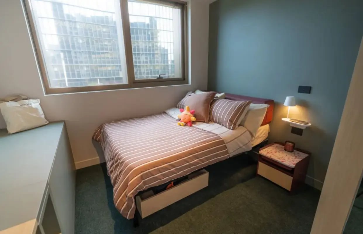 Bed with toy bedside table and lamp bedroom at The Switch Berkeley in Melbourne Student Accommodation