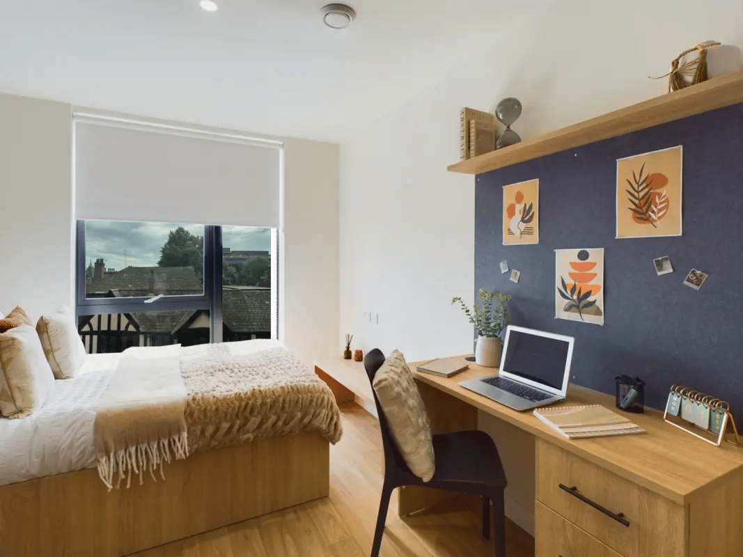 Bed desk laptop and calendar bedroom study area at Straits Aire in Leeds Student Accommodation