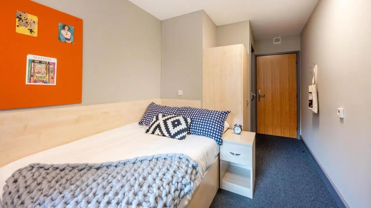 Bed bedside table wardrobe door and bulletin board bedroom at The Forge in Sheffield Student Accommodation